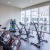 gym with peloton, cycling equipment and large windows