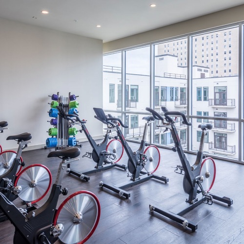gym with peloton, cycling equipment and large windows gym with peloton, cycling equipment and large windows